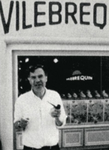 black and white photo of a man in front of Vilebrequin's storefront