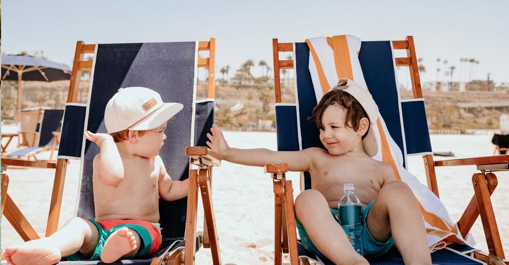 two children in beach chairs