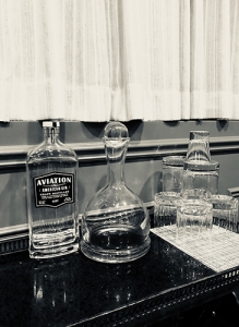 black and white photo of glasses stacked on a table