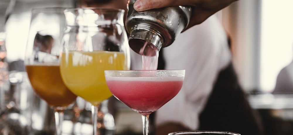 cocktail being poured into a glass