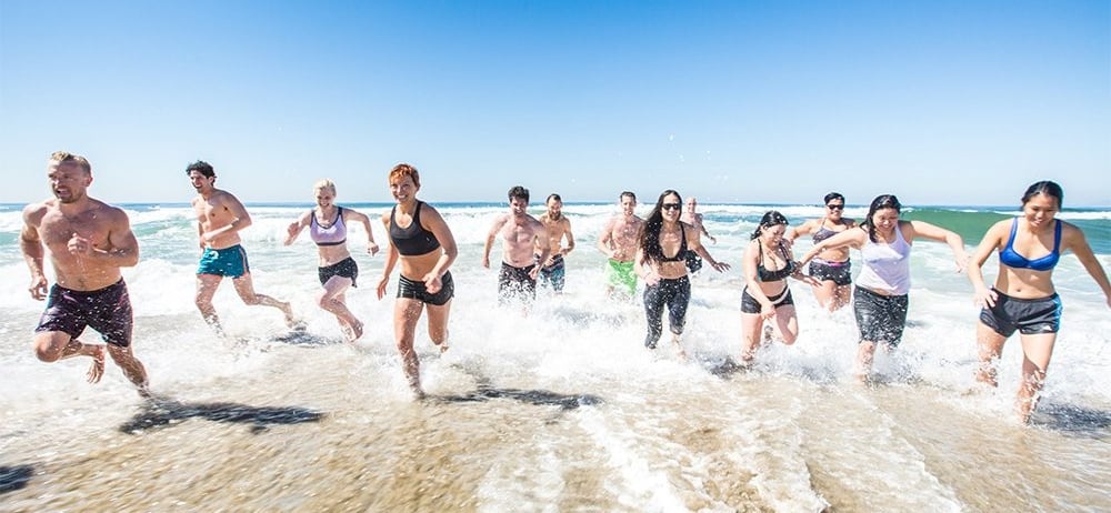 group running along the beach