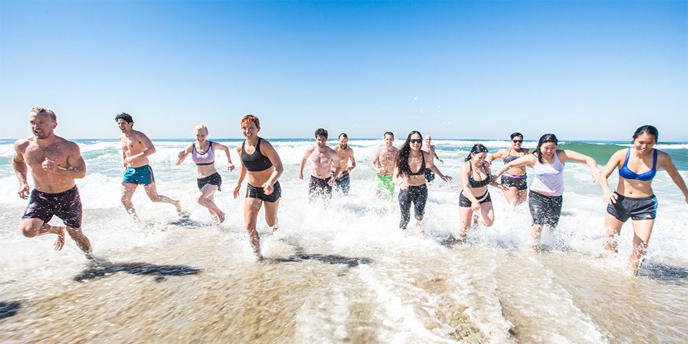 group running along the beach
