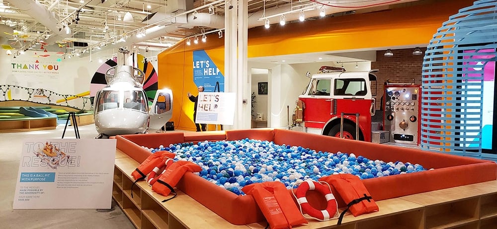 large colorful children's play room with a ball pit