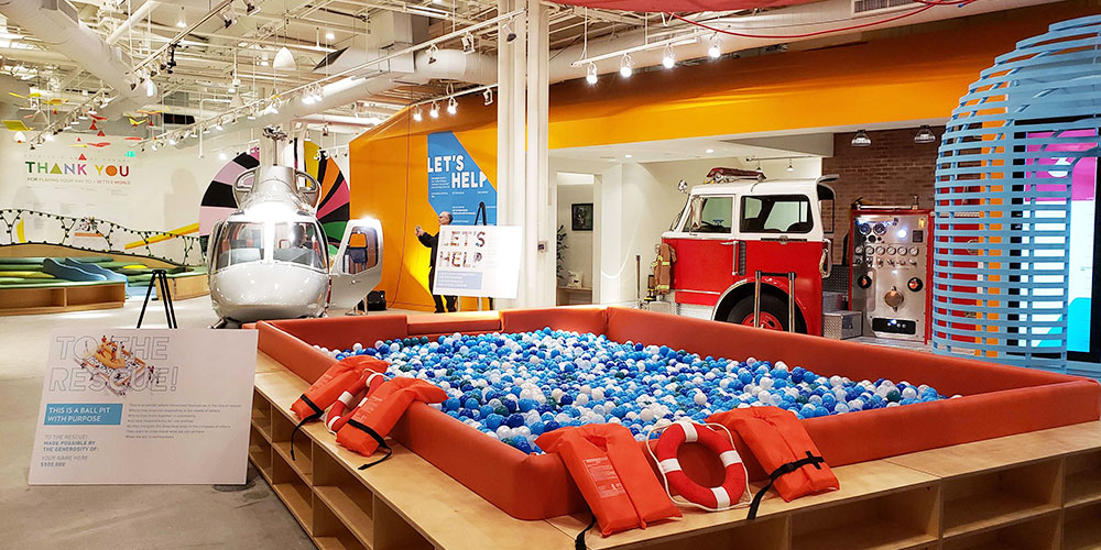 large colorful children's play room with a ball pit