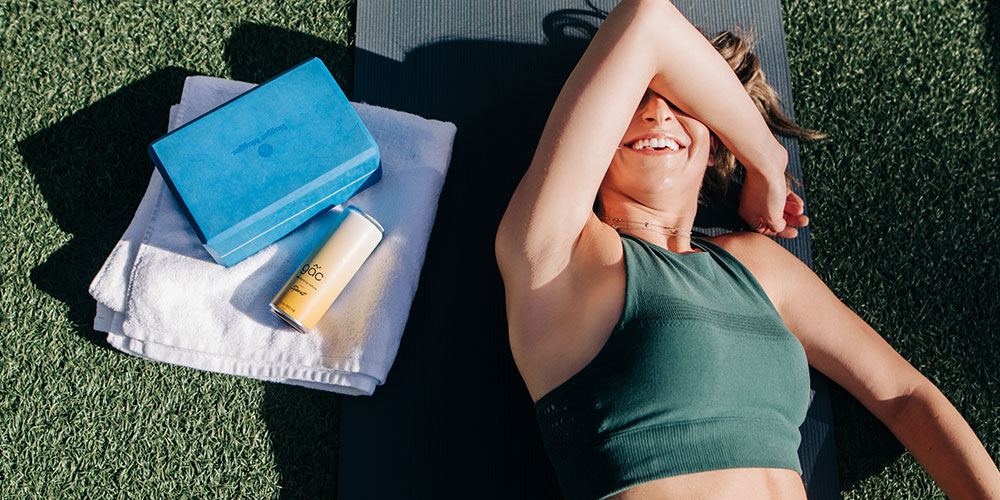 woman laying on a yoga mat