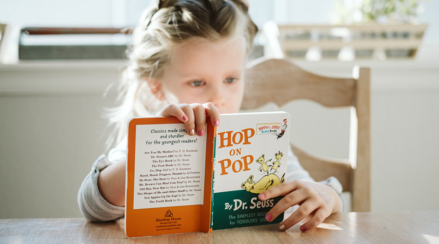 child reading Hop on Pop by Dr.Seuss