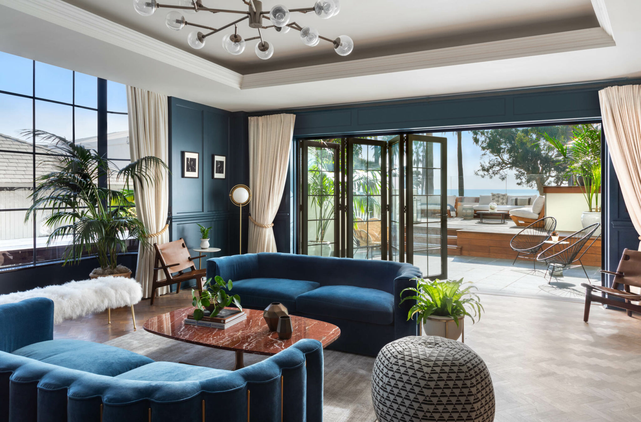 sitting room with blue couches and view of terrace