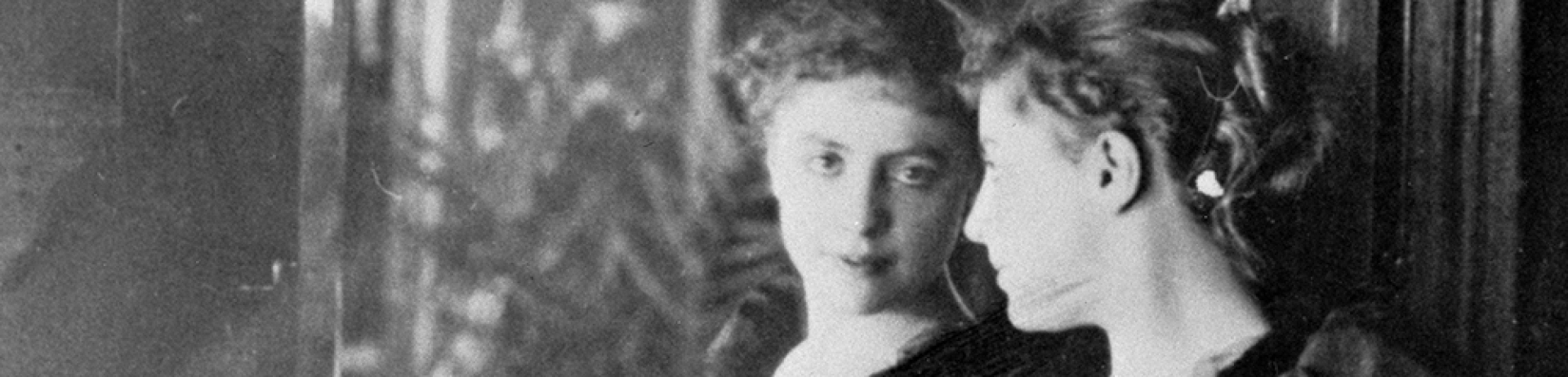 black and white photograph of Georgina Jones looking at her reflection in a mirror