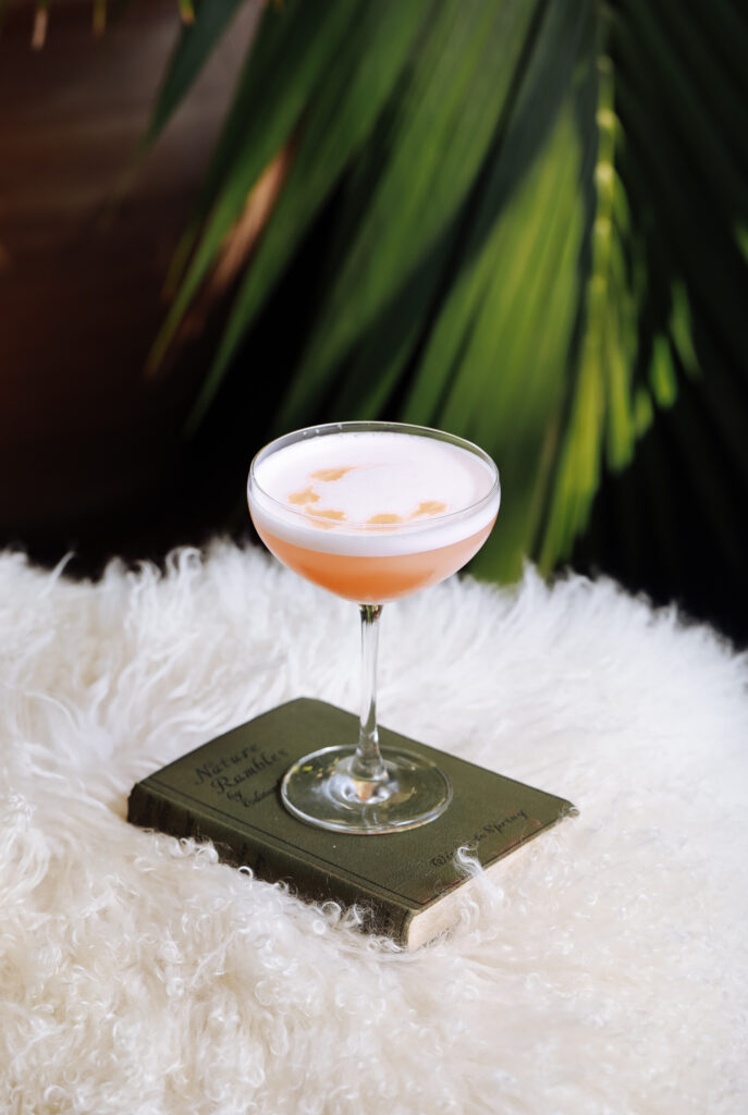 peach cocktail on a book
