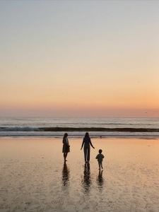 family on beach at sunset