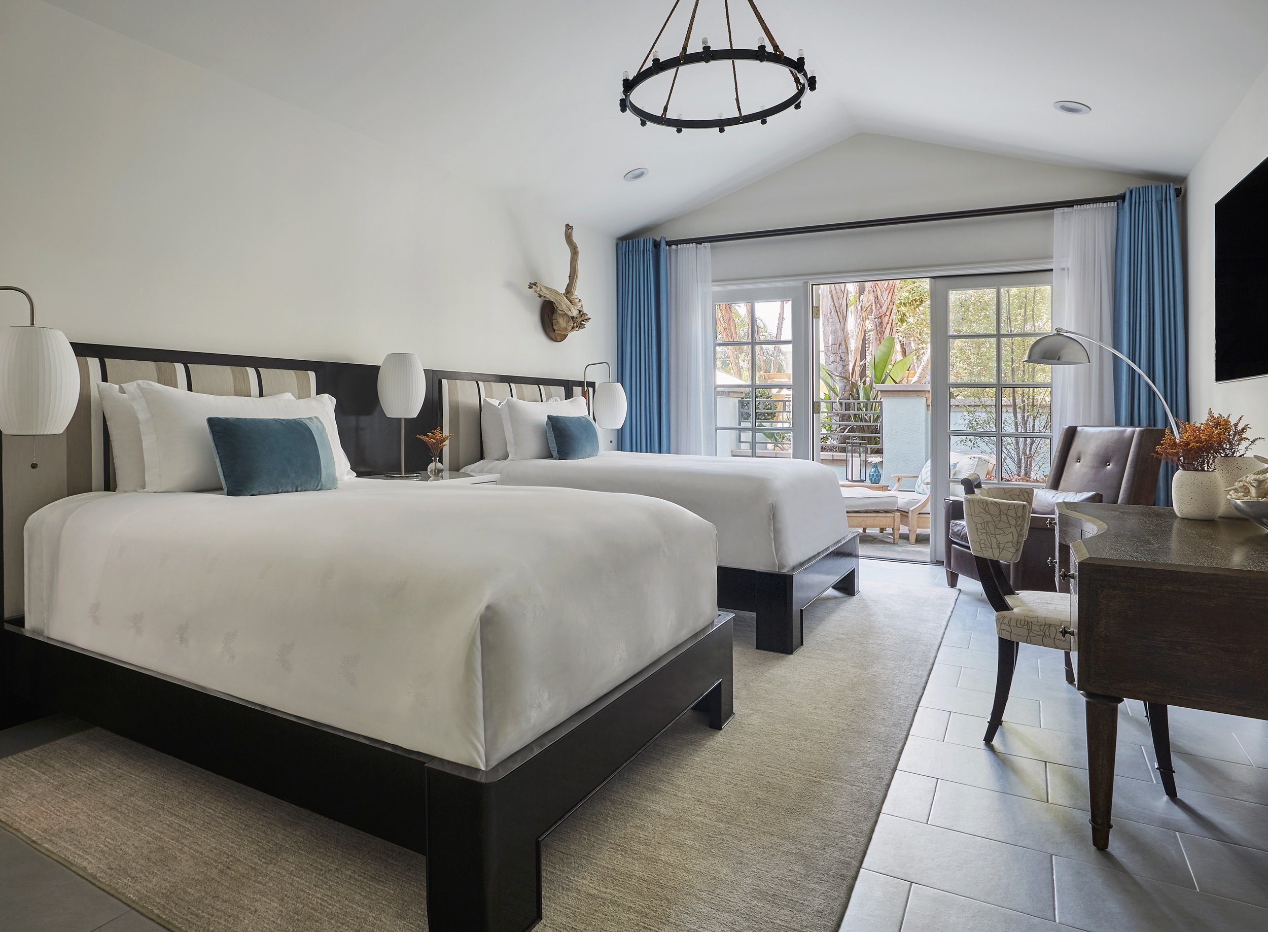 view of two beds with view out of window