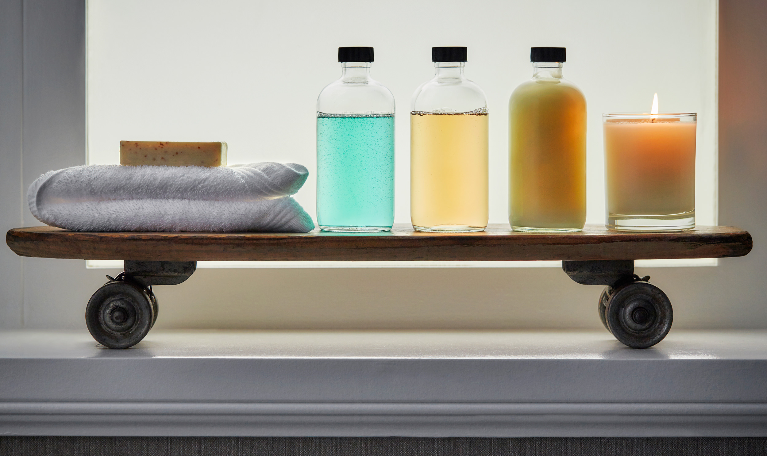 a window sill with bath oils on it
