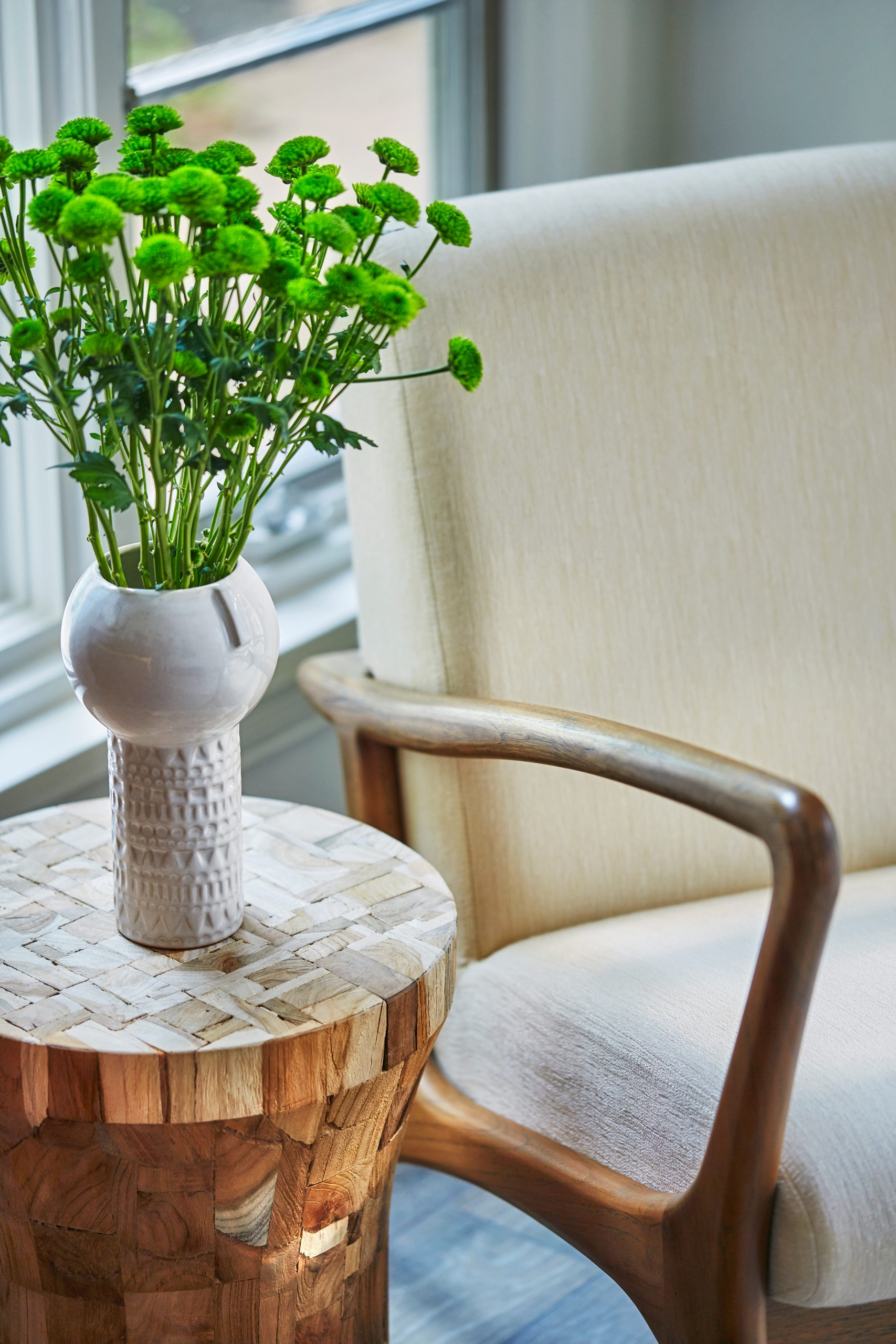 a chair and small table with plant on it