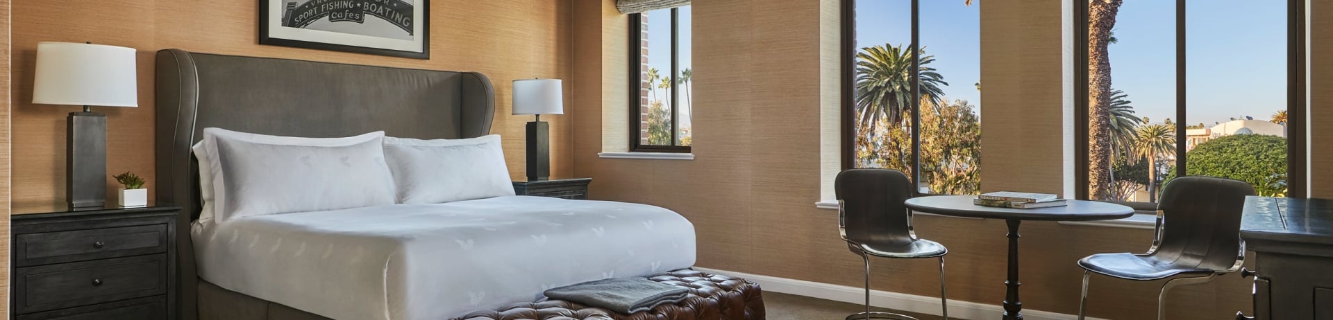 a double bed, open windows and a sunny day