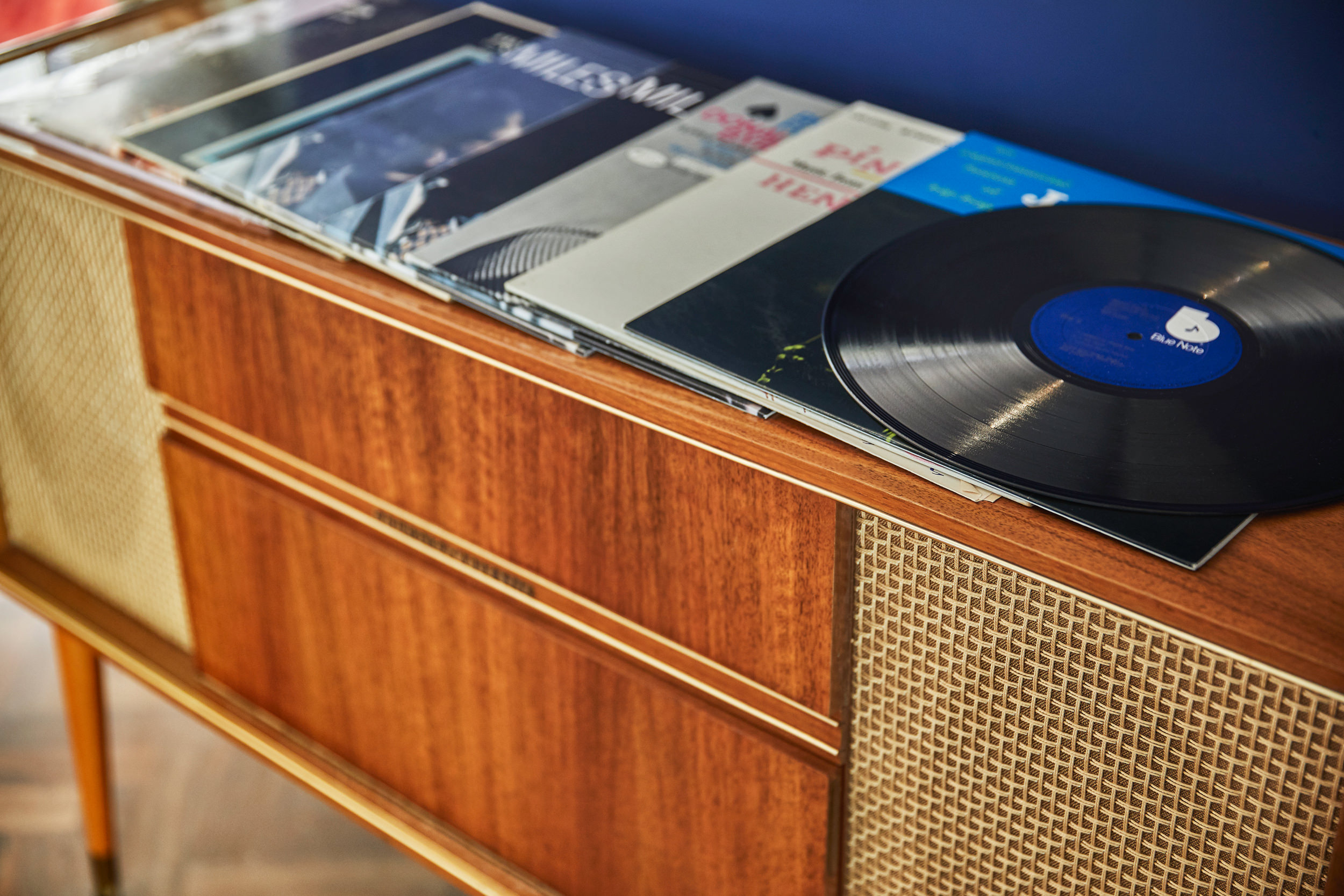 A Speaker with vinyl records on top