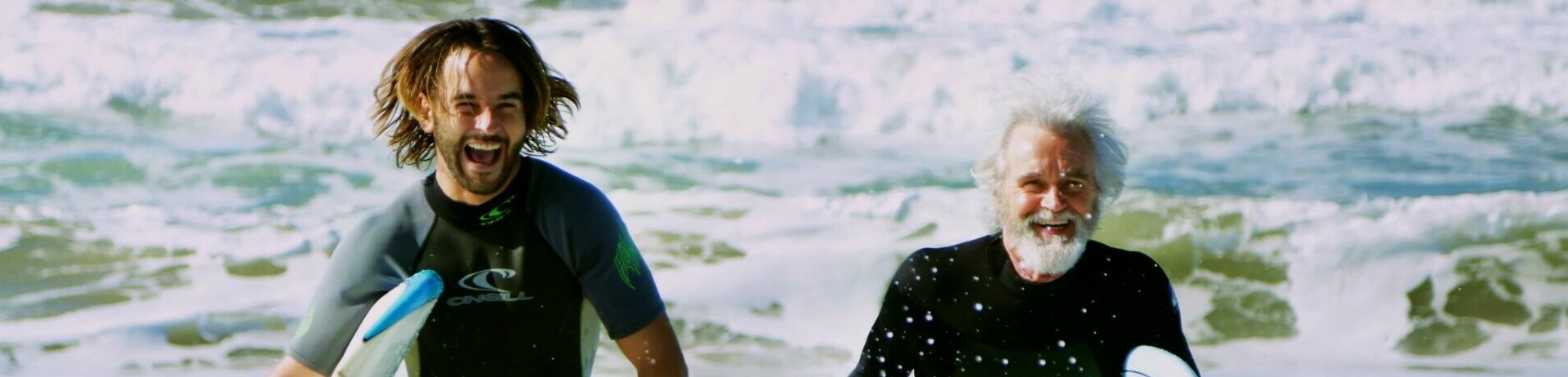 two surfers walking in the ocean