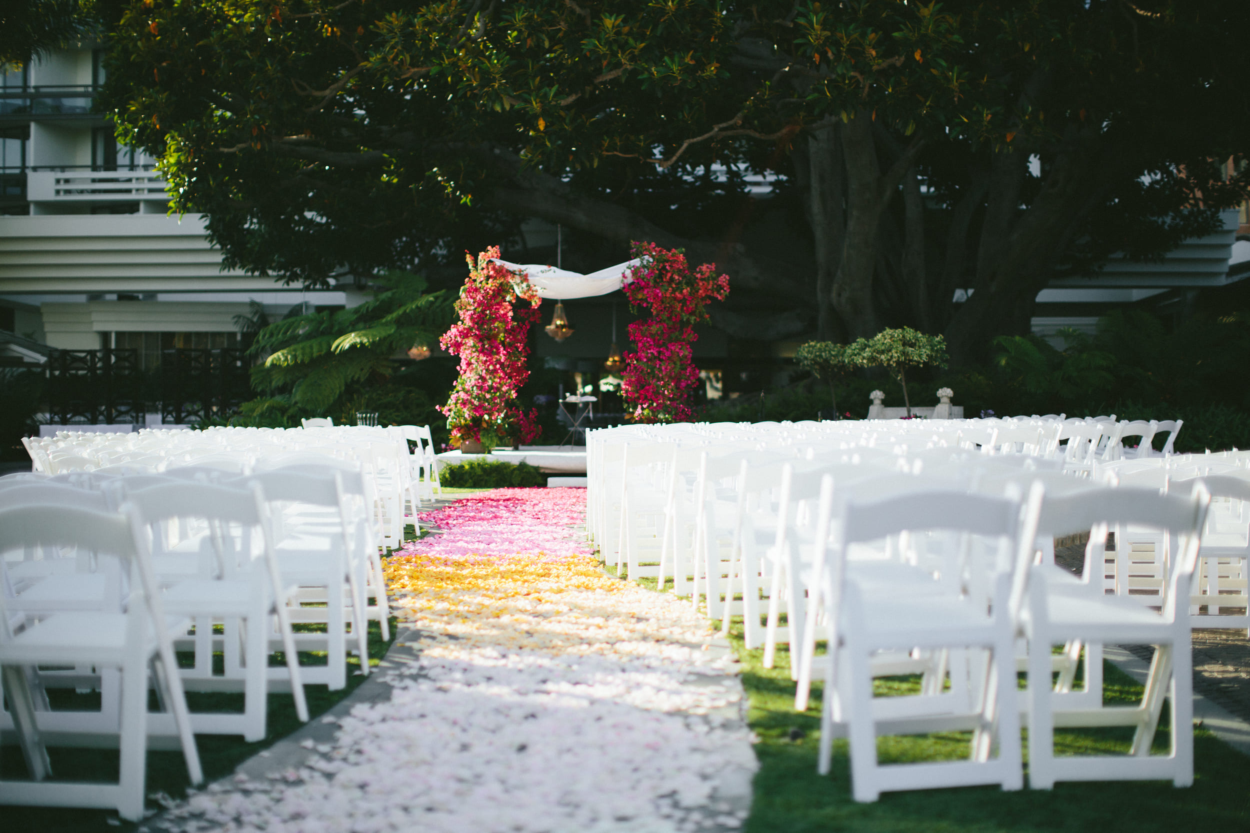 outdoor wedding set up with bright flower petals