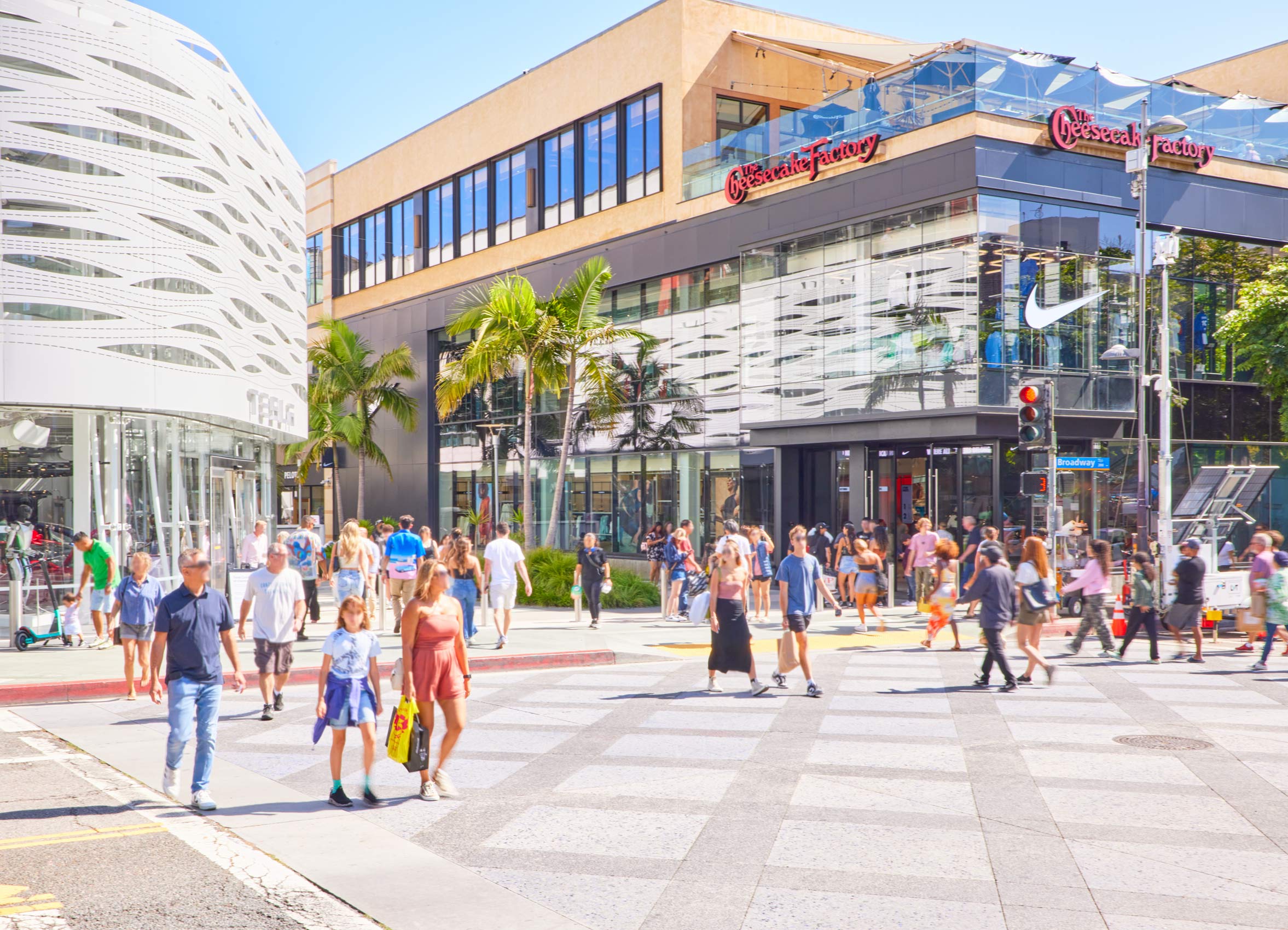 an outdoor mall with people walking through it