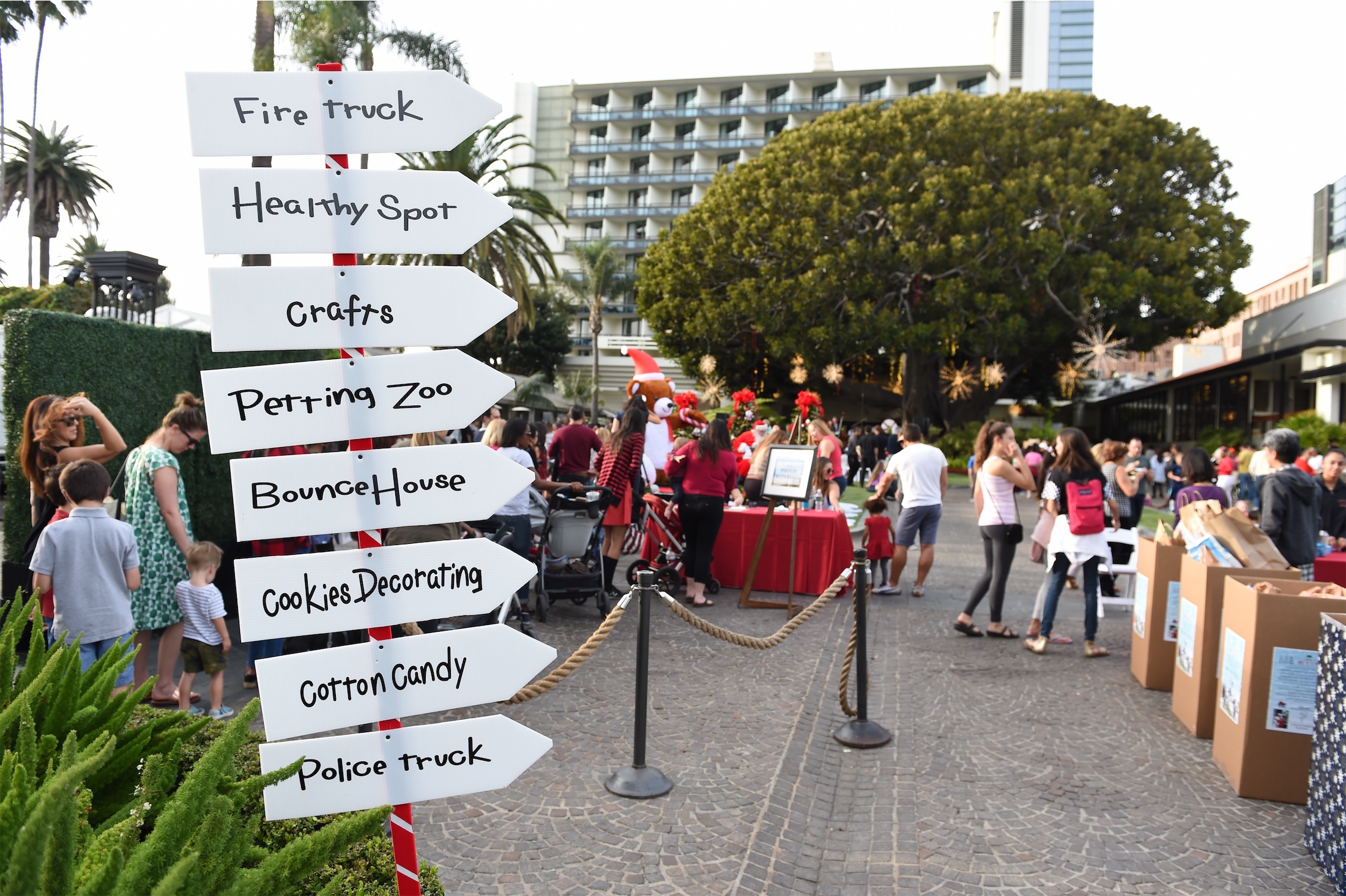 Sign of activities in front of crowd at the Meet Me Under The FIG Tree event at Fairmont Miramar