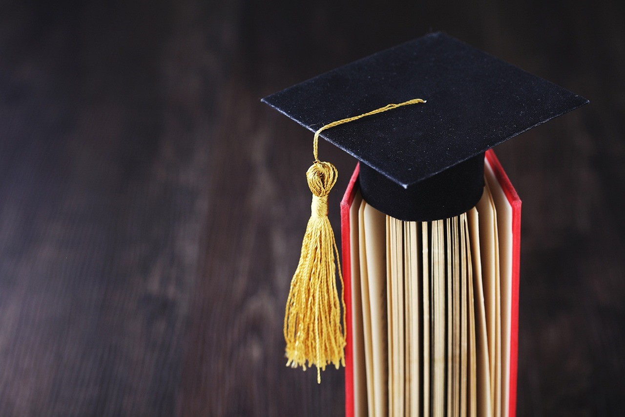 graduation cap on top of a book