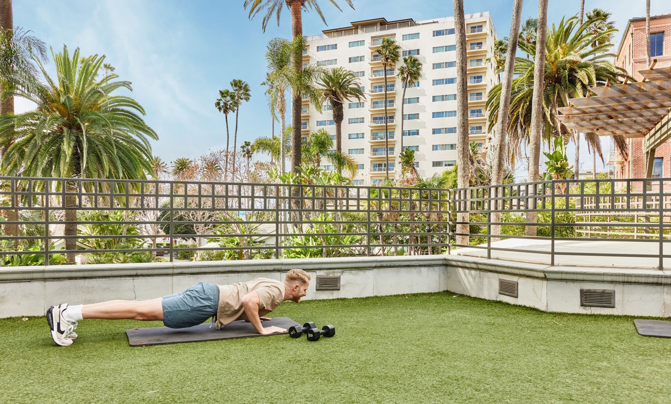 a man doing a push up on an outdoor studio