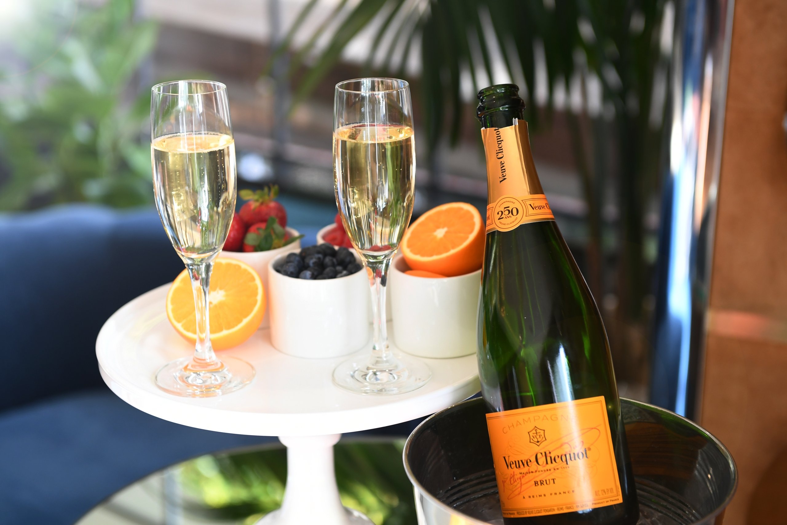 a bottle of champagne and fruits